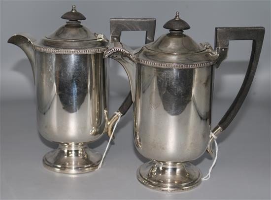 A silver cylindrical coffee pot and matching hot water jug, Sheffield 1939.